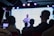 A group of professionals engaged in a training session with a projector screen.