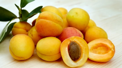 yellow round fruits on white table