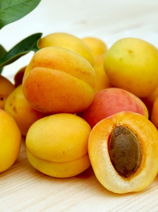 yellow round fruits on white table