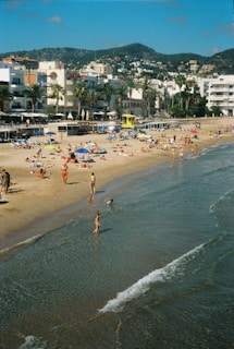 A sunny beach area with families lounging and playing.