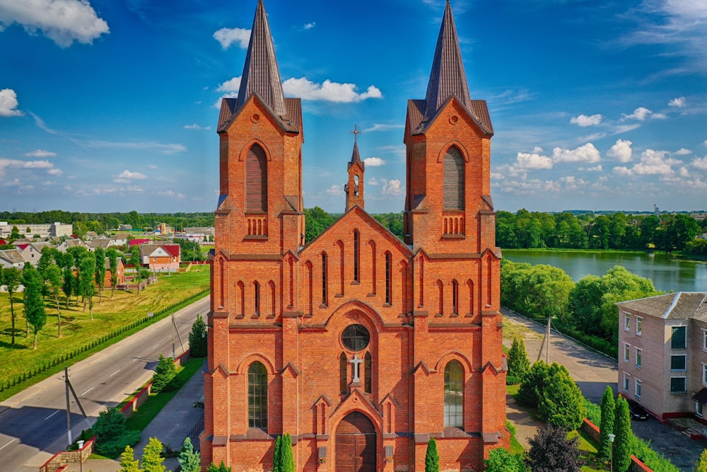 brown concrete church near green grass field during daytime