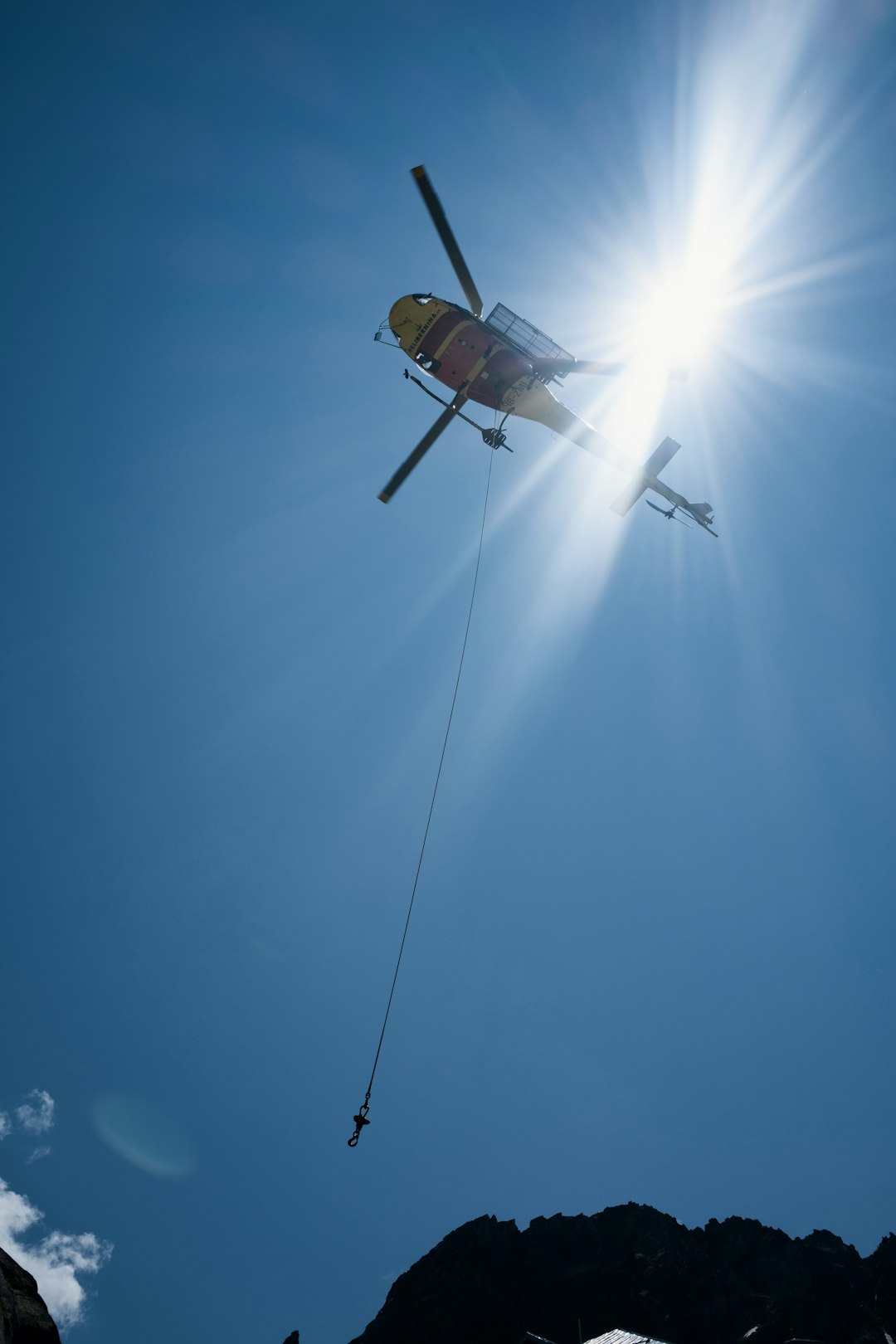 white and black helicopter flying in the sky during daytime