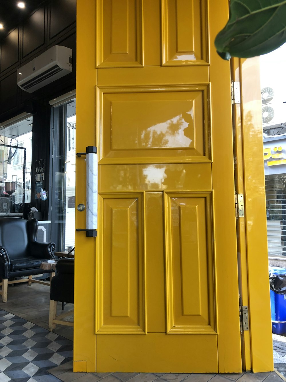 yellow wooden door near black office rolling chair