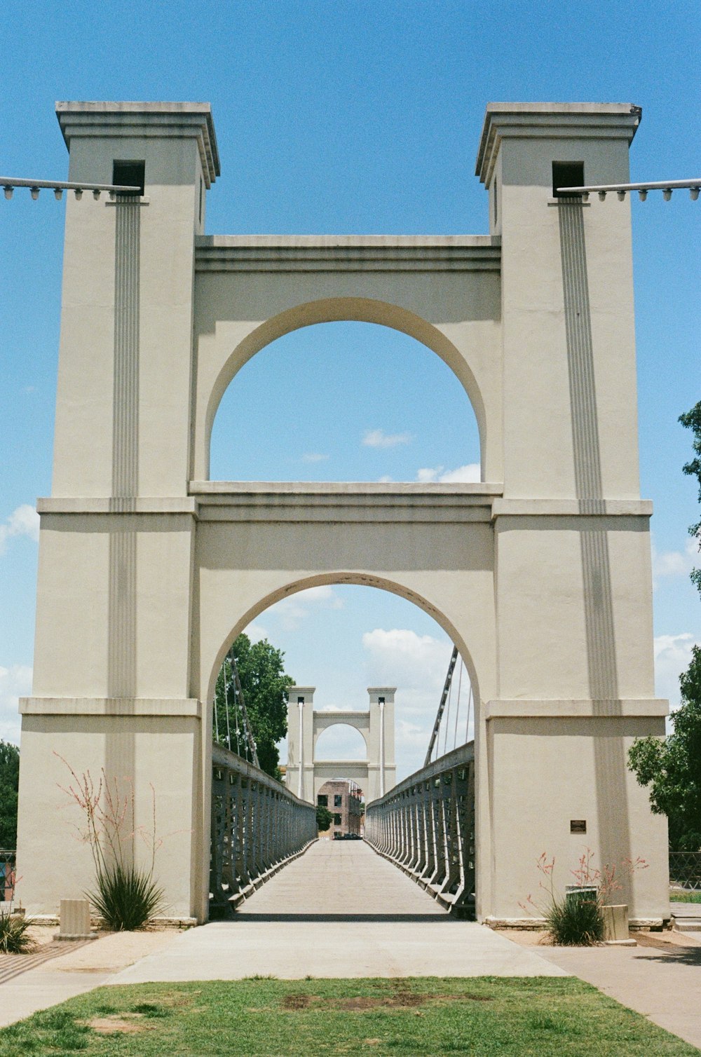 white concrete arch bridge under blue sky during daytime