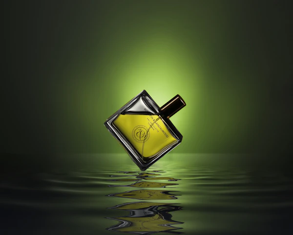 gold colored and black perfume bottle on water