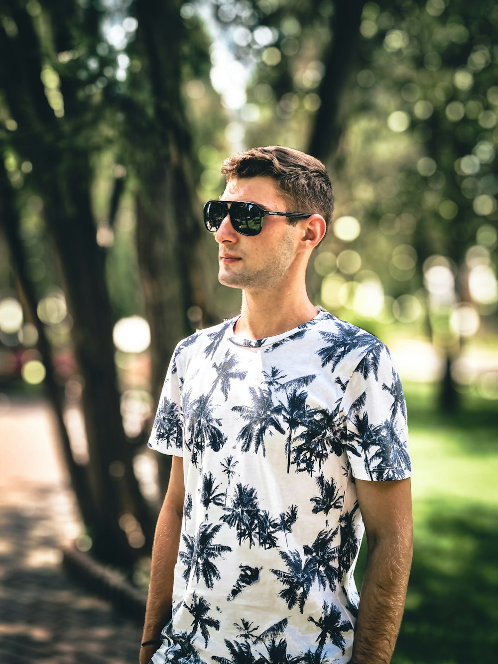 man in white and blue floral crew neck t-shirt wearing black sunglasses
