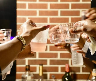 person holding clear drinking glass