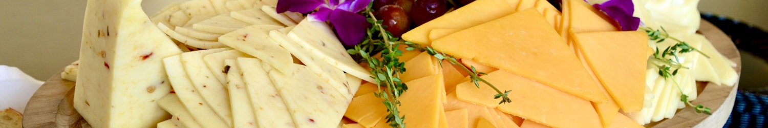 sliced cheese on brown wooden chopping board