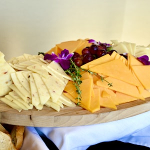 sliced cheese on brown wooden chopping board