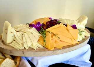 sliced cheese on brown wooden chopping board