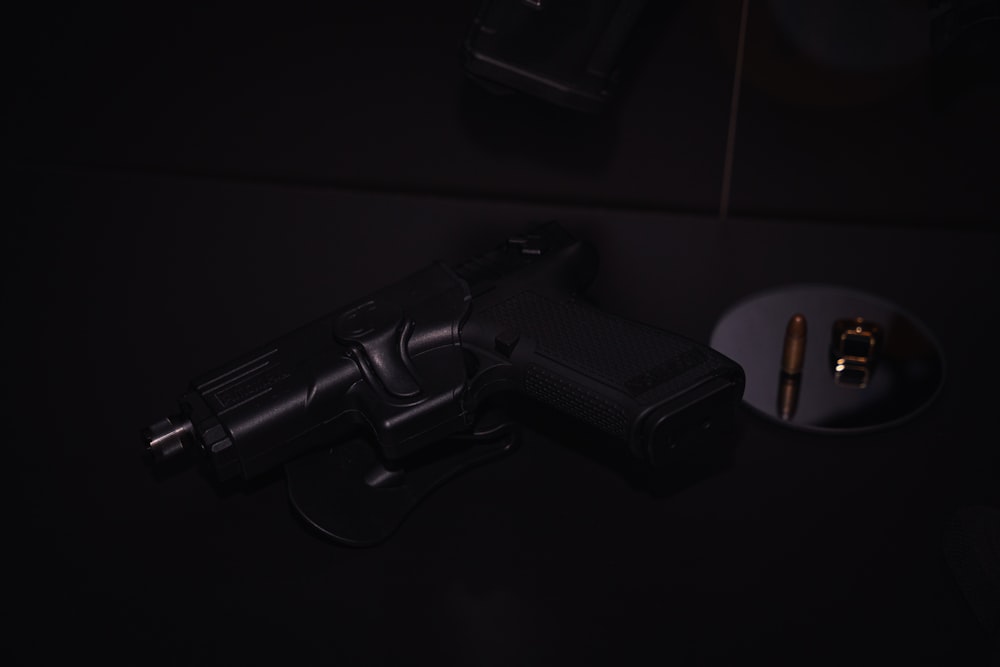 black semi automatic pistol on black surface