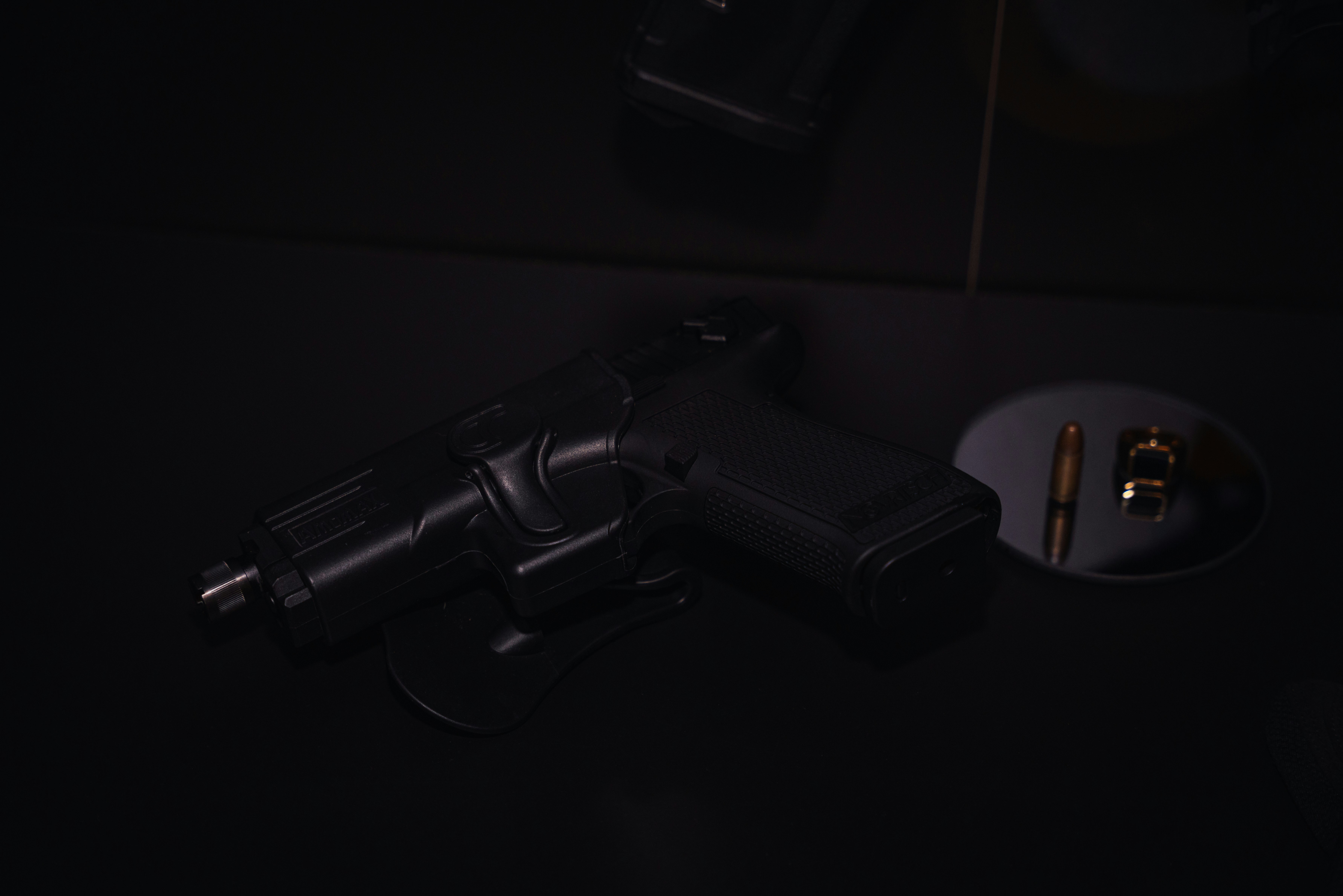 black semi automatic pistol on black surface