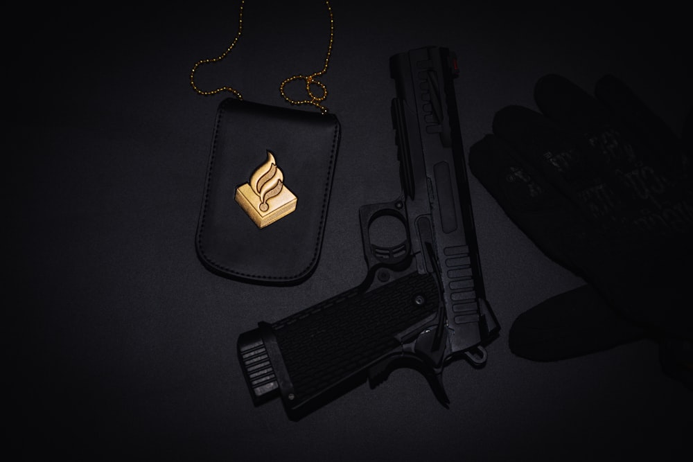 black semi automatic pistol on black textile