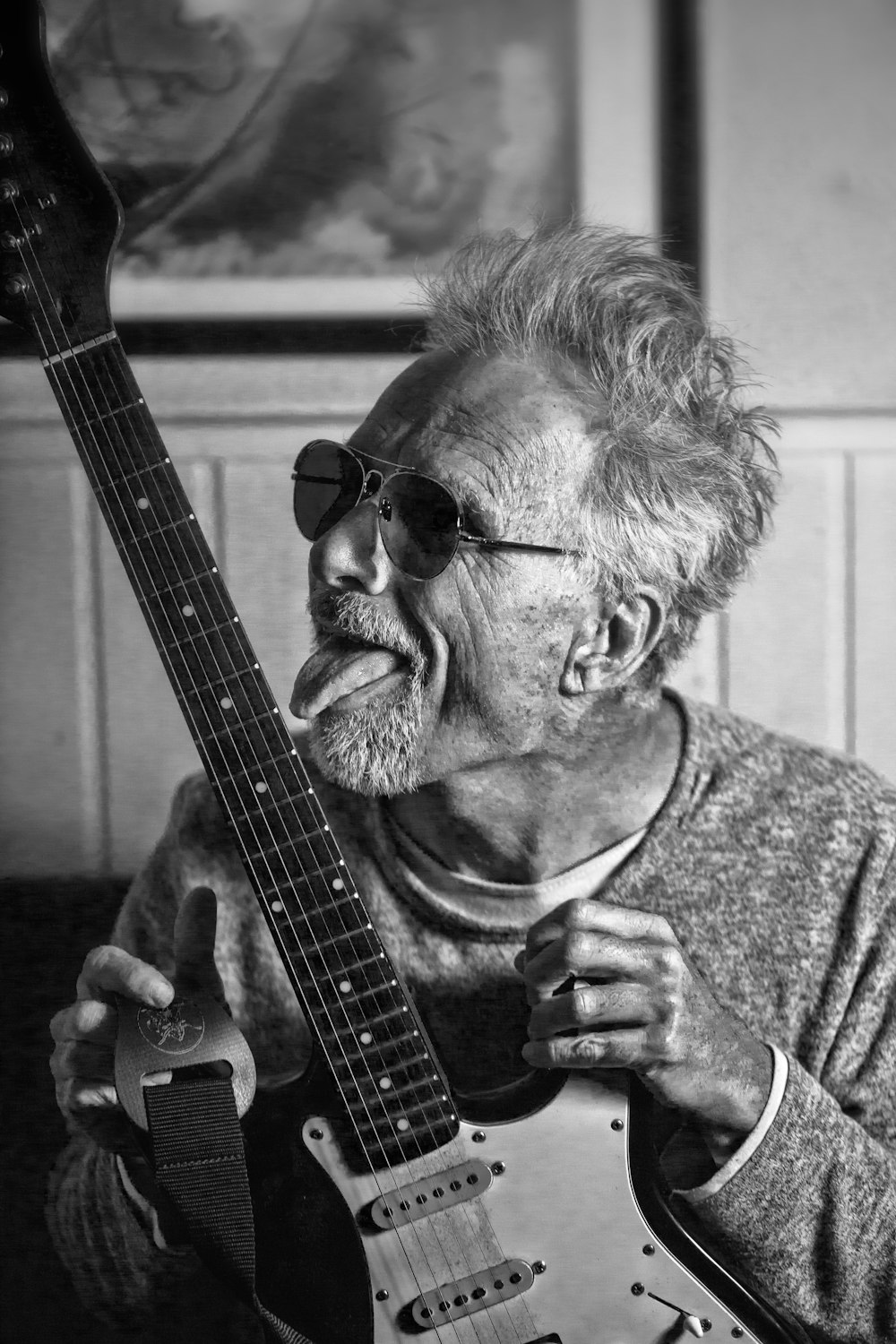 man in black sunglasses playing guitar