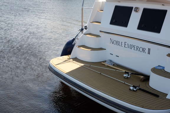 white and blue boat on body of water during daytime