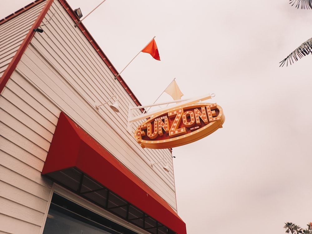 red and white concrete building with red and white flag during daytime