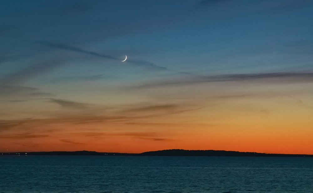 body of water during sunset