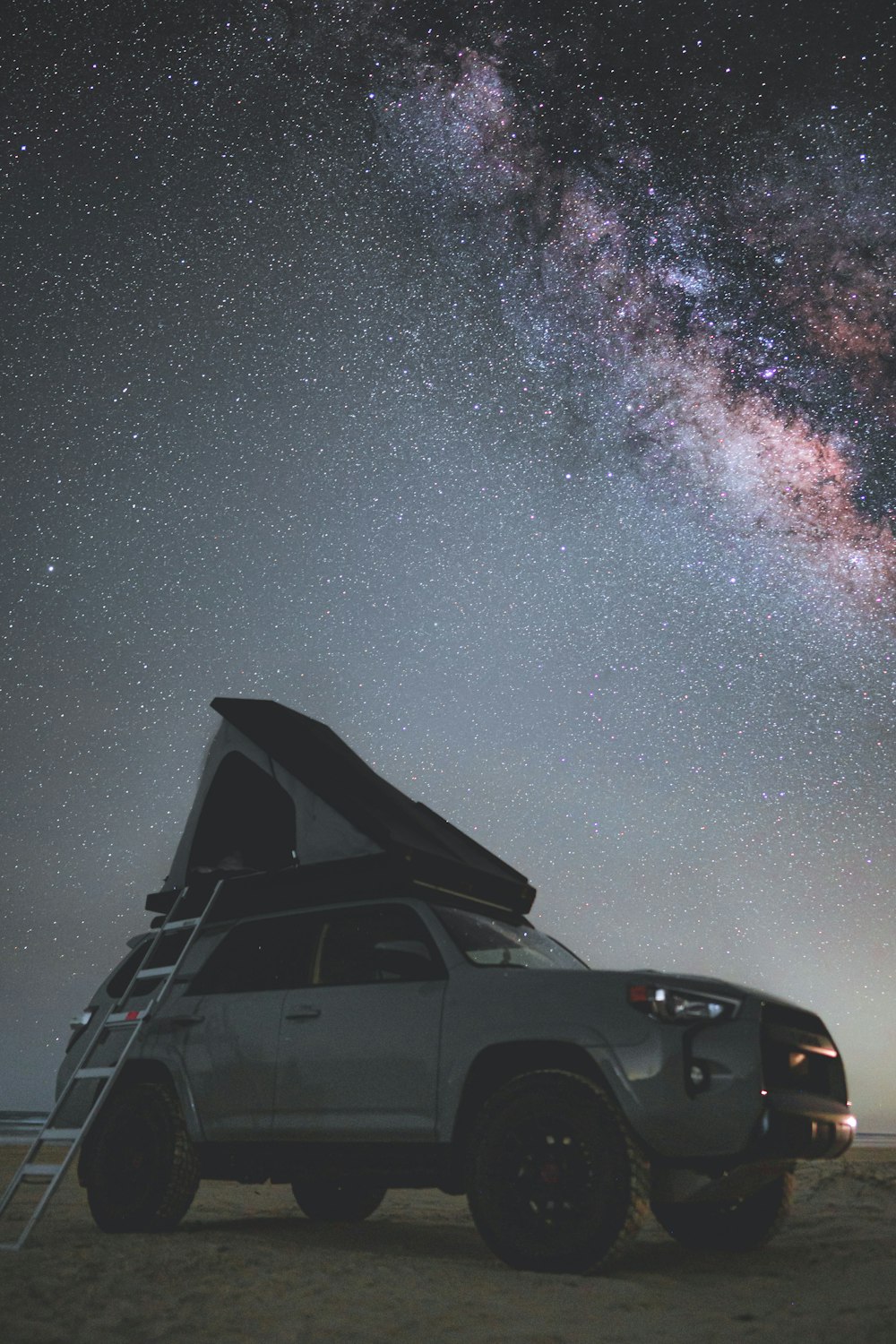 black suv under starry night