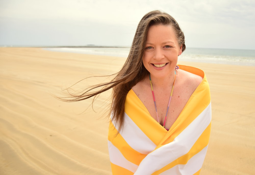 woman in yellow and white striped dress on beach