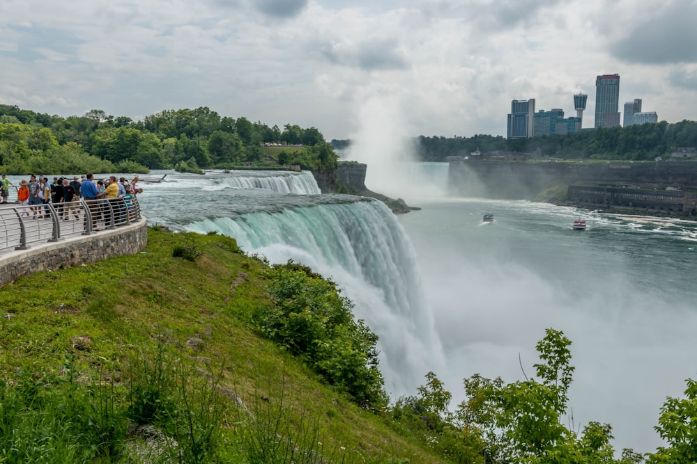 white and red boat on water falls during daytime