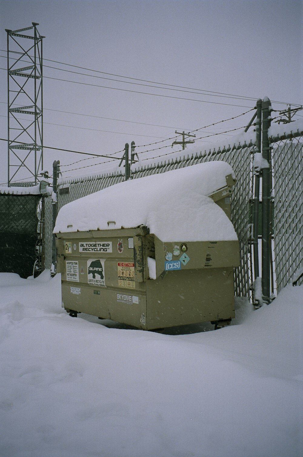 brown and white box truck covered with snow