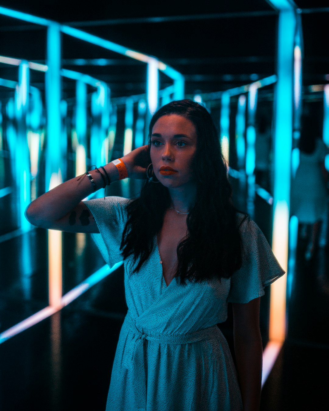 woman in blue dress standing near blue light