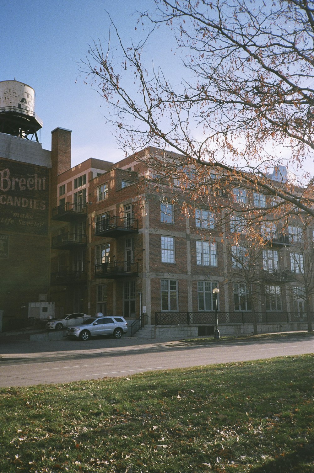 cars parked in front of brown building