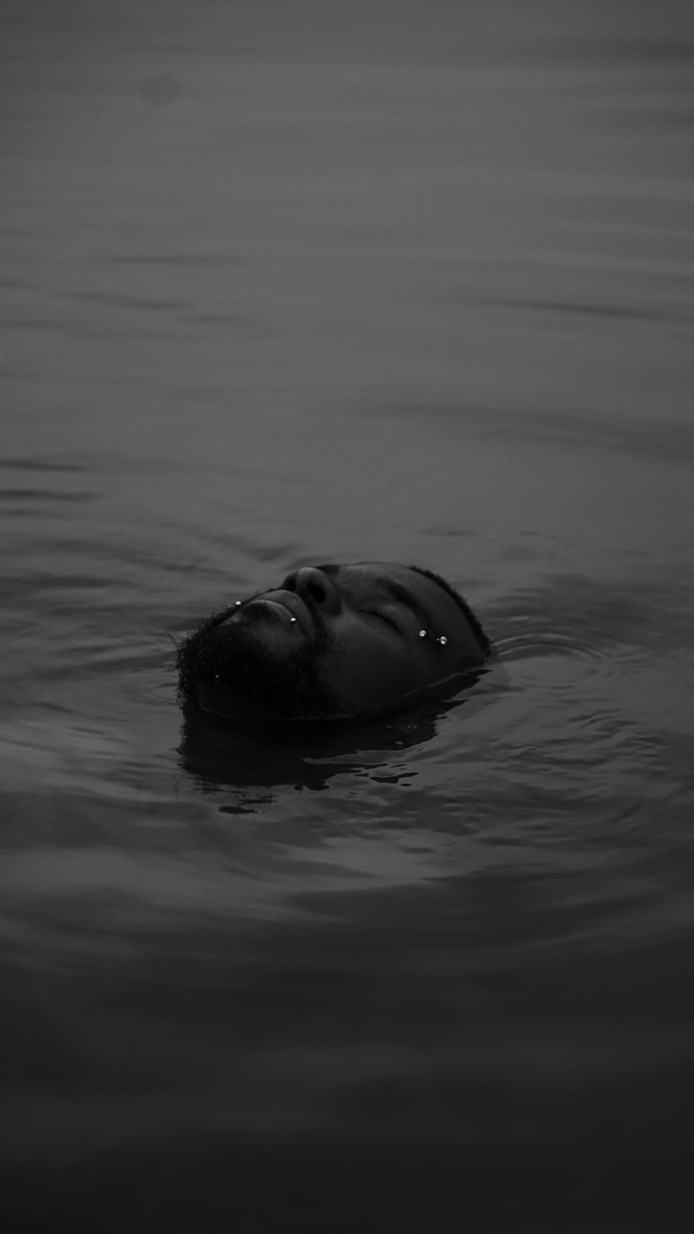 grayscale photo of man in water