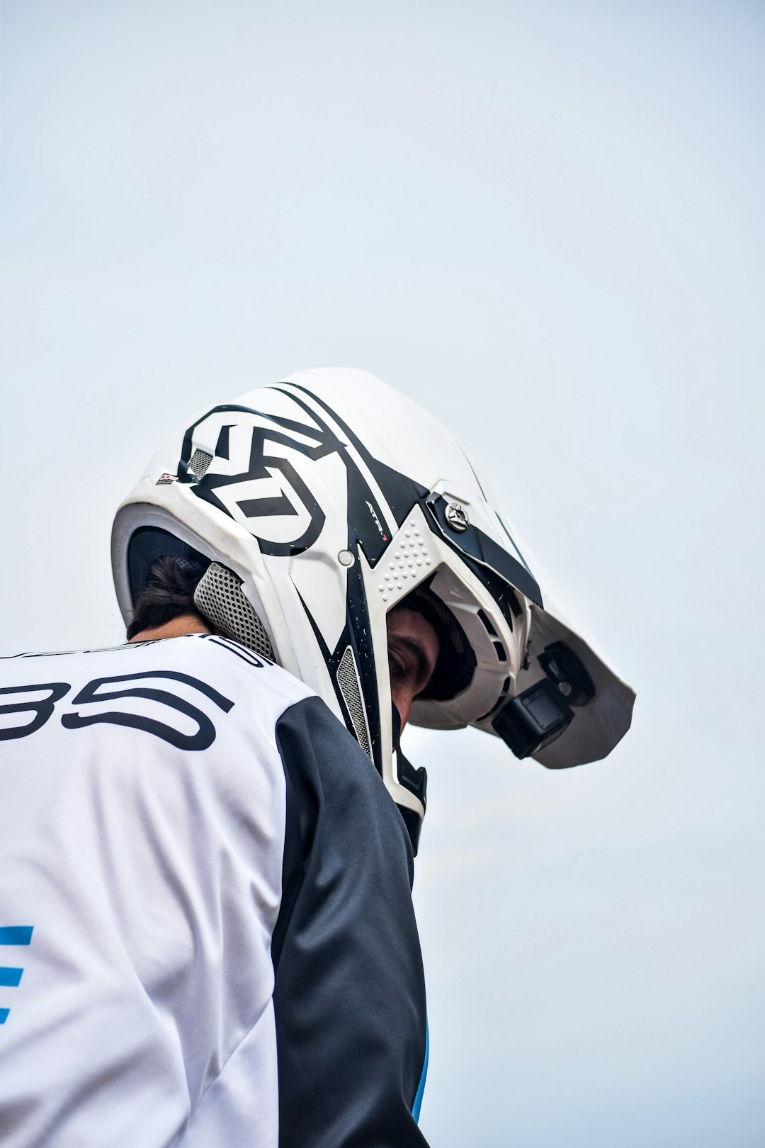 man in white and black helmet and white and black hoodie