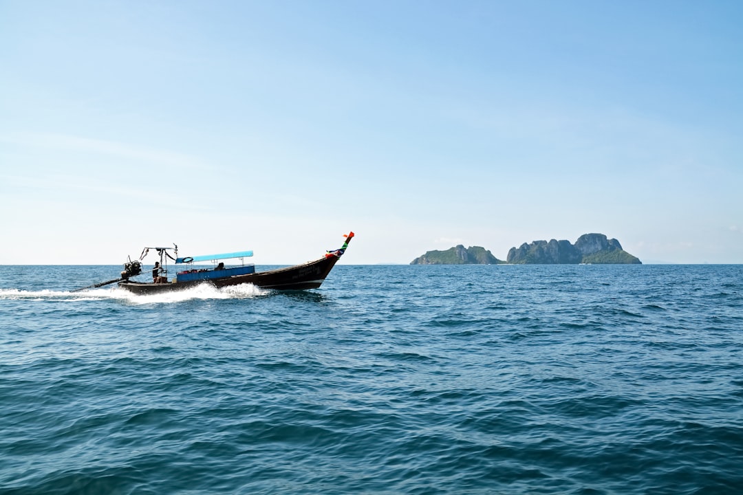 black and red boat on sea during daytime