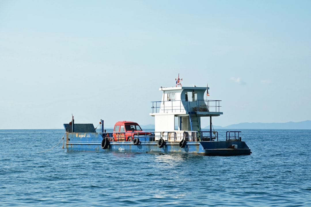 white and red boat on sea during daytime