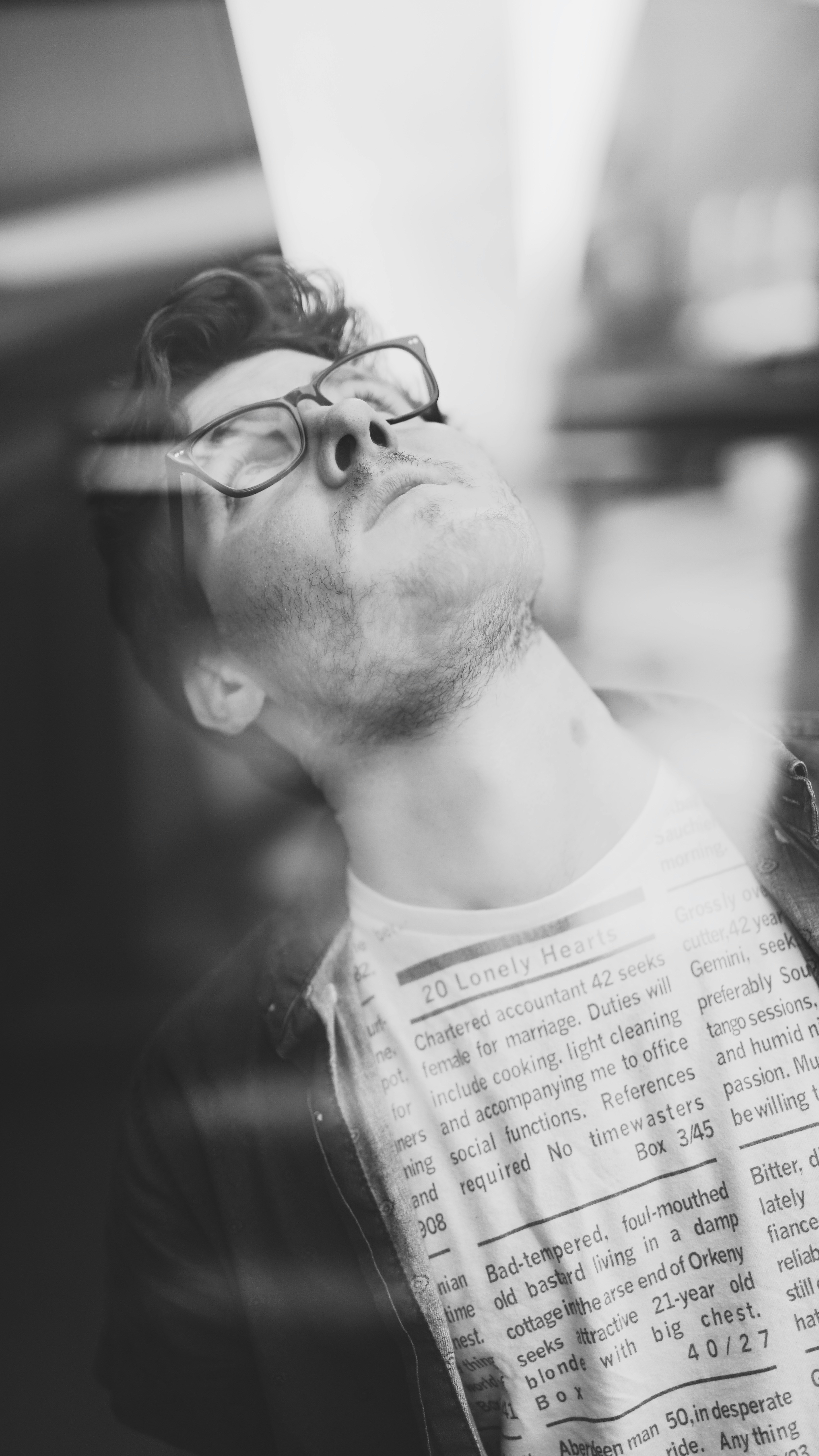 man in white crew neck shirt wearing black framed eyeglasses