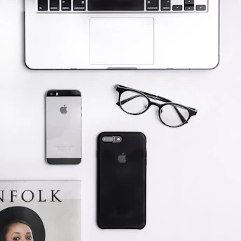 A stylish flat lay of elegant sales materials including brochures and digital devices