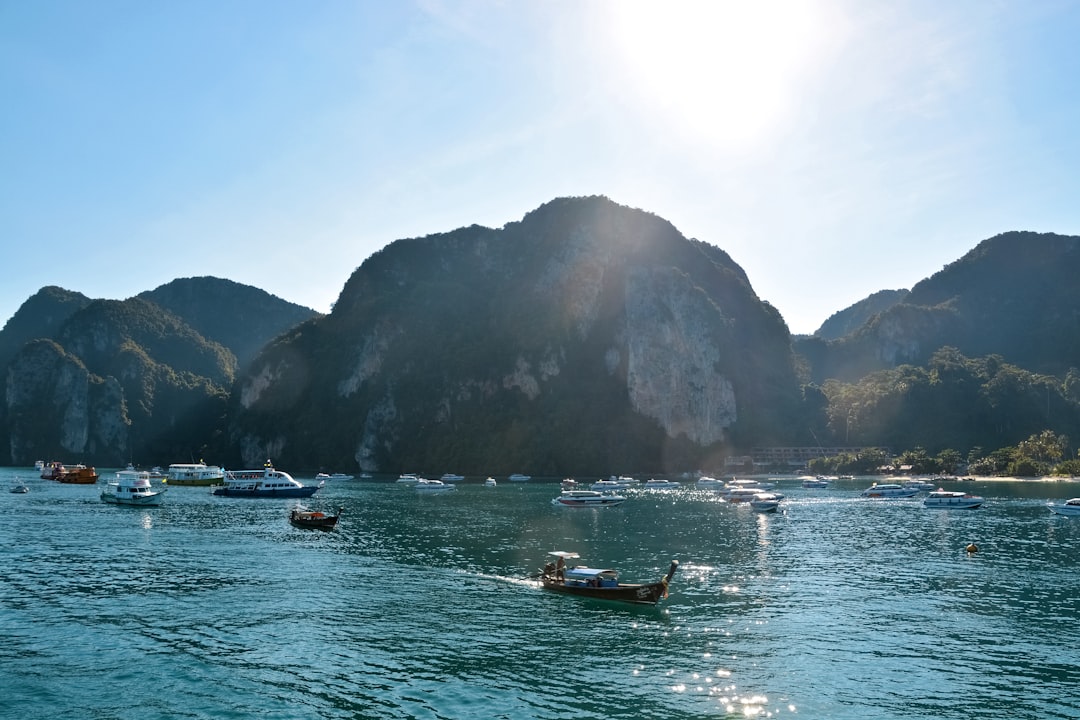 boat on sea near mountain during daytime