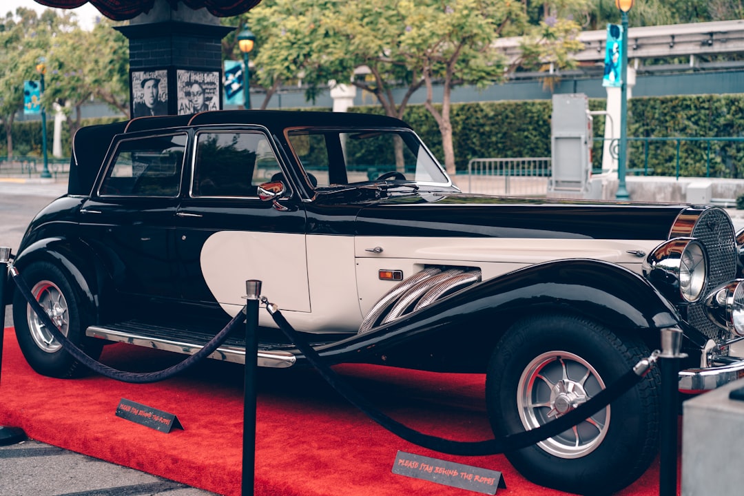 black vintage car on red carpet