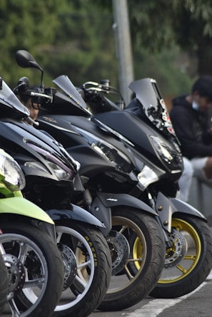 A group of Taruqa motorcycles lined up in a stylish display.