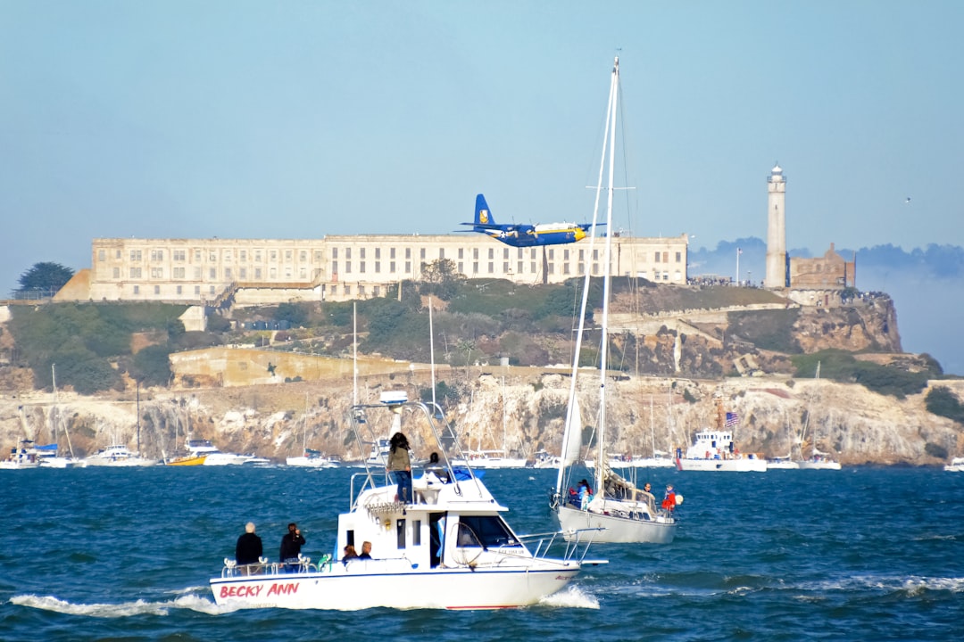 people riding on white and blue boat on sea during daytime