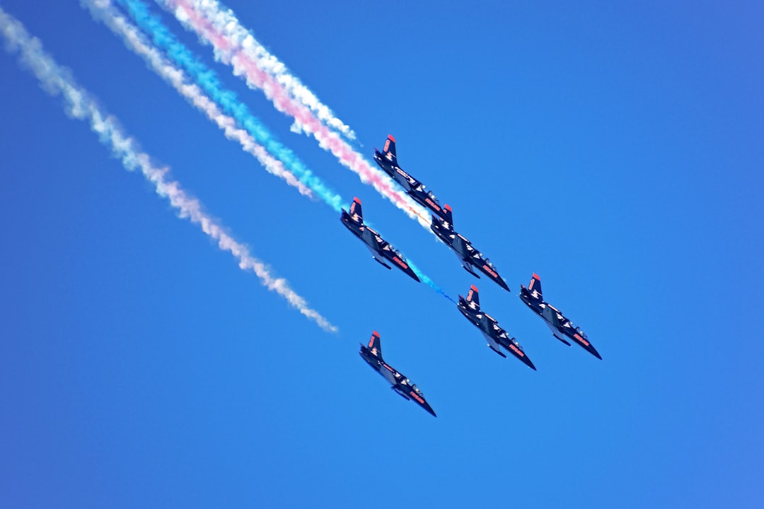 red and blue jet planes in mid air