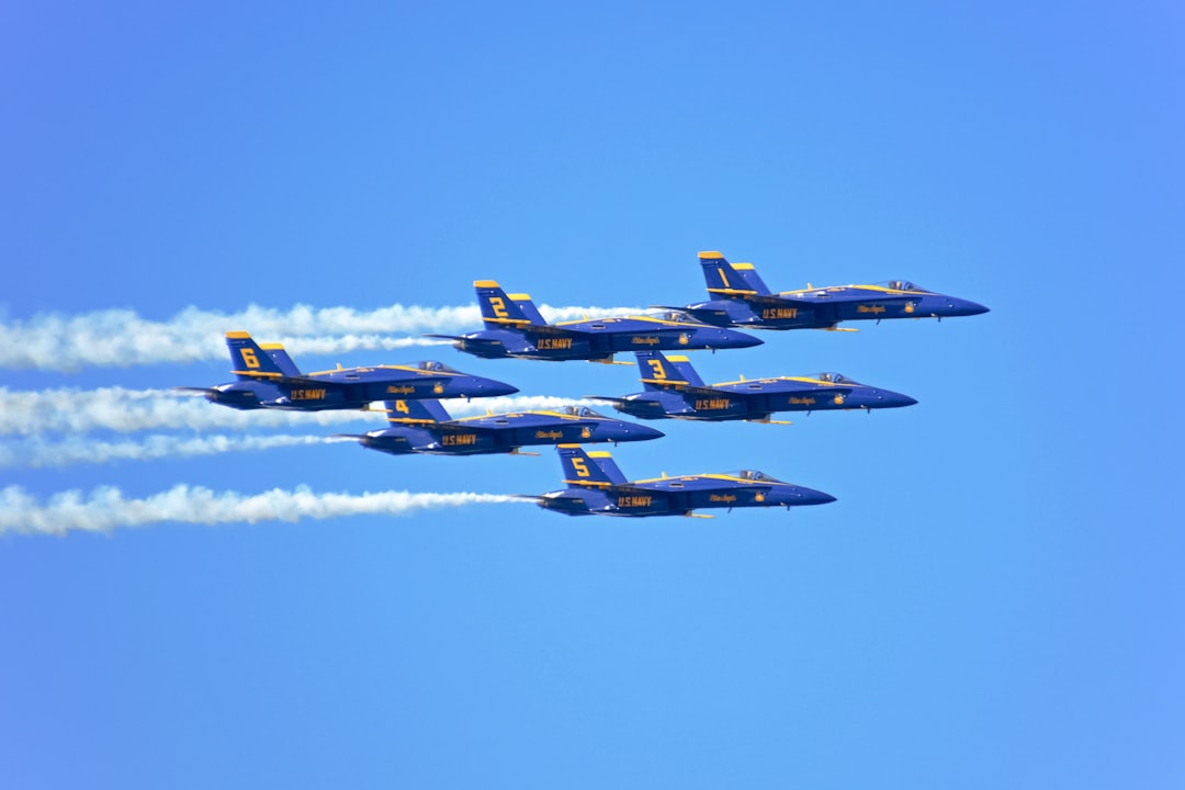 four fighter planes flying in the sky during daytime