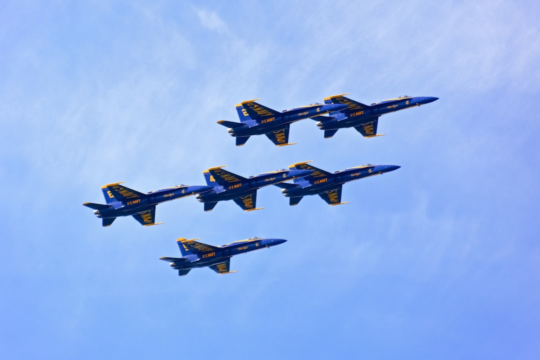 four fighter planes flying in the sky during daytime