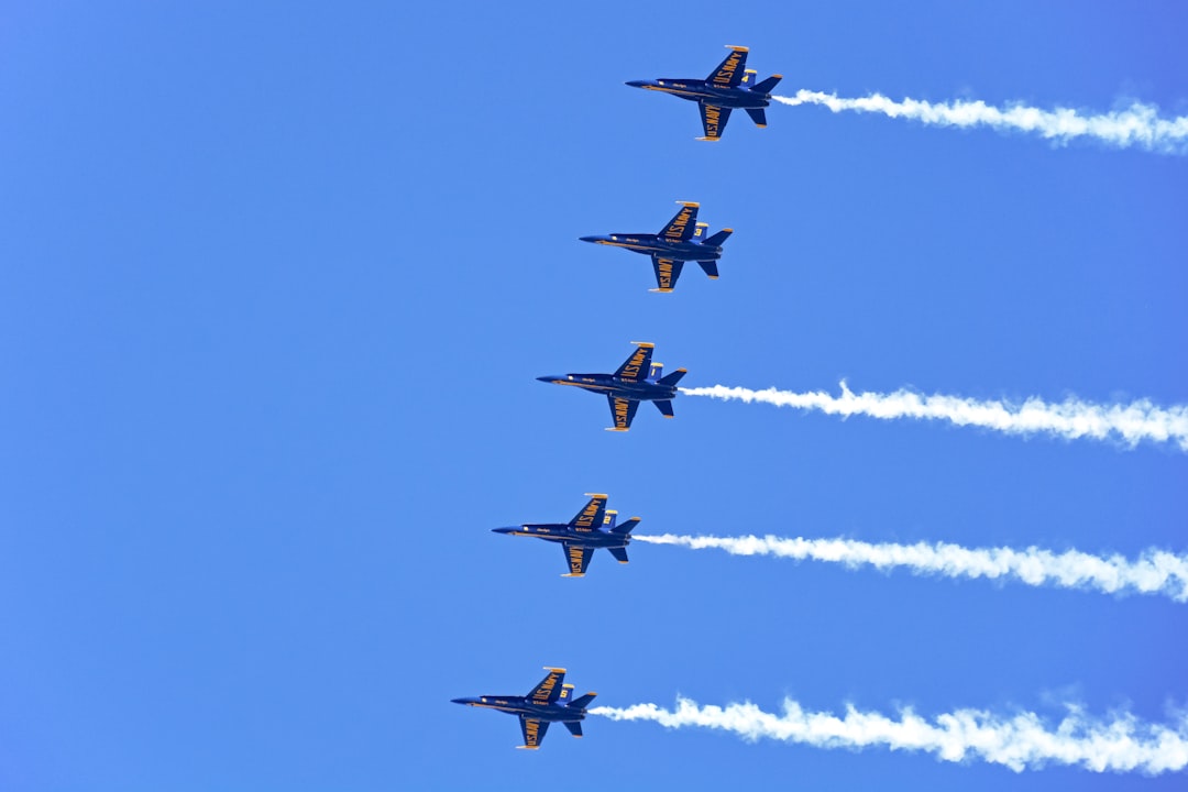 four fighter planes in mid air during daytime