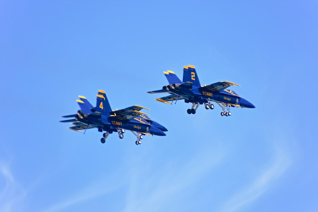 blue and yellow fighter plane in the sky