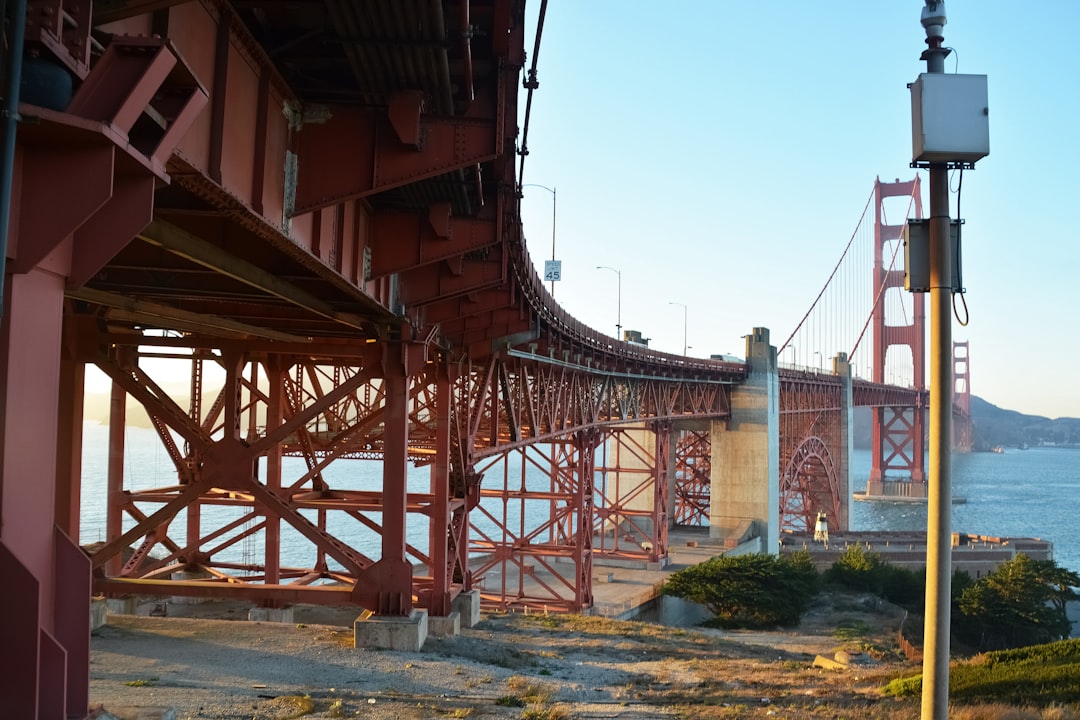 brown metal bridge under blue sky during daytime