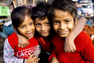 boy in red crew neck shirt beside boy in black crew neck shirt