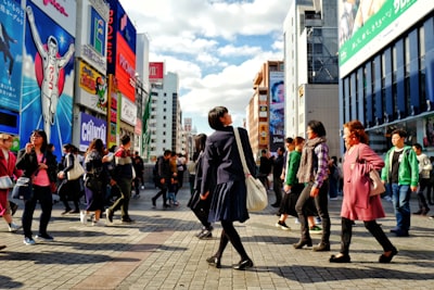 people walking on sidewalk during daytime lively google meet background