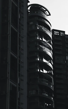 Ultra-realistic image of a modern luxury residential building with sleek black and gold accents.