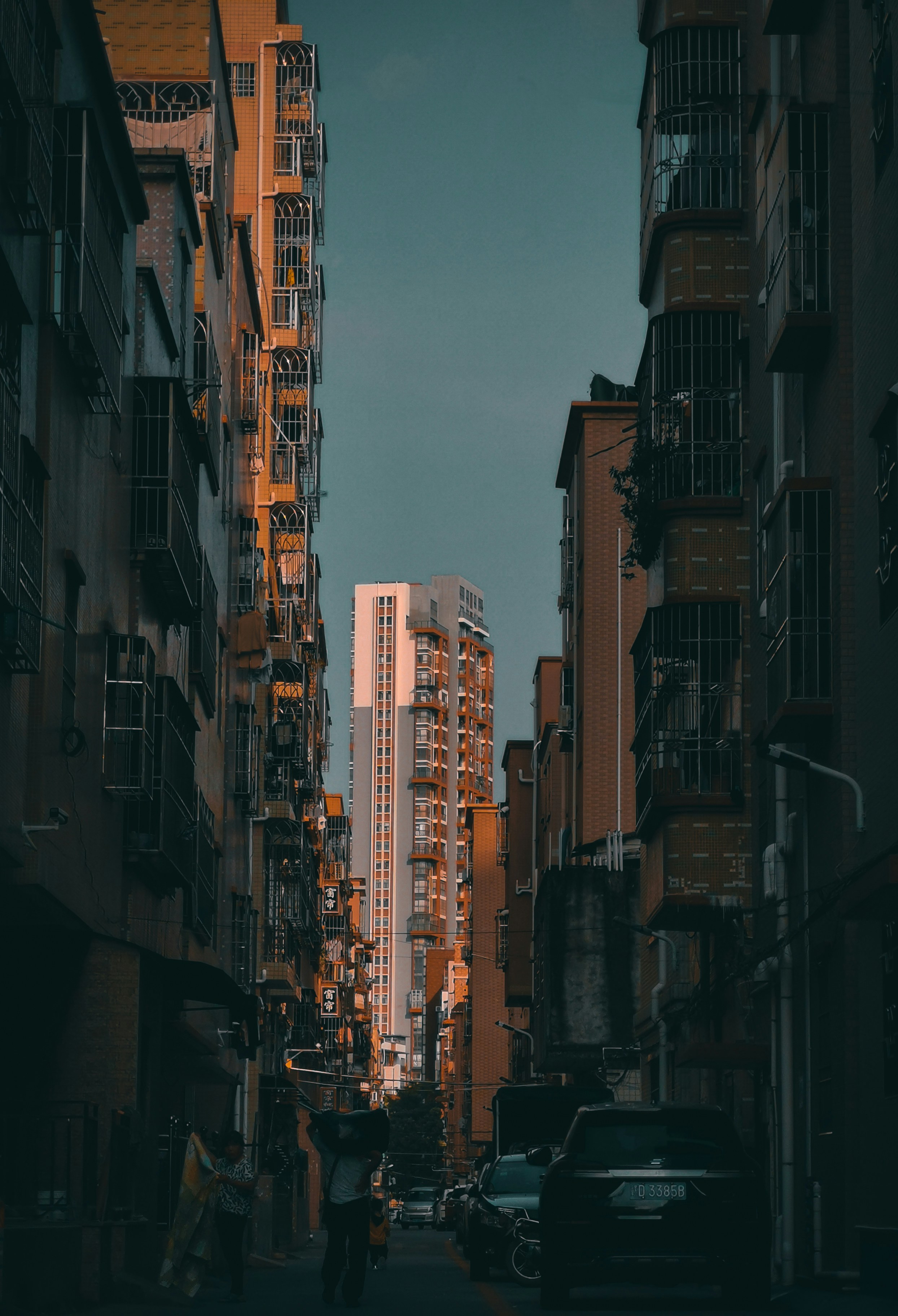 people walking on street between high rise buildings during daytime