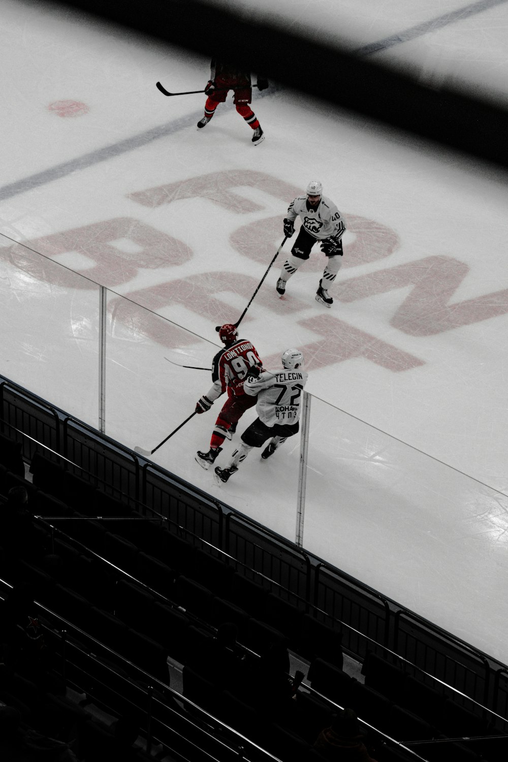 man in white and black ice hockey jersey shirt and black pants playing hockey