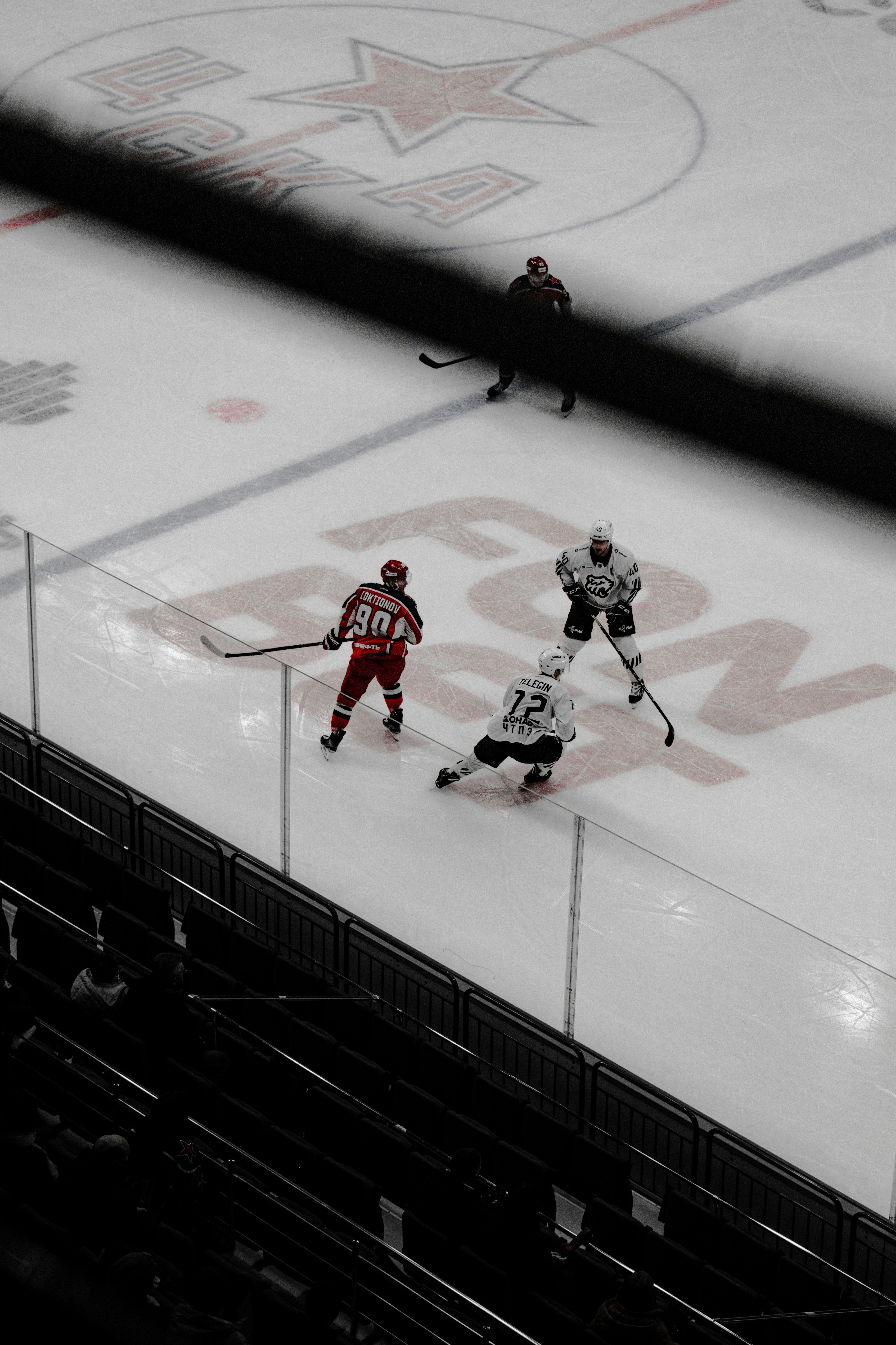 man in red and white ice hockey jersey playing hockey