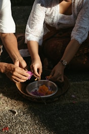 Volunteers arranging fresh flowers and cleaning the temple courtyard.